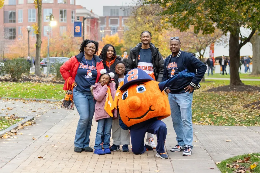 Family posing with Otto on campus.